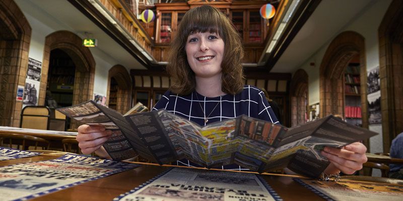 University of Leeds graduate Dominique Triggs poses with newly released Leeds theatre heritage walking trail at Leeds Central Library.