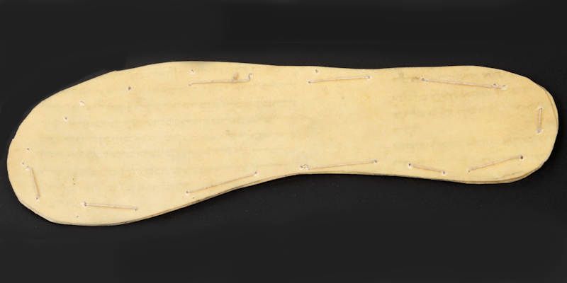A leather child’s shoe sole crudely cut from a Jewish religious parchment scroll – a Sefer Torah.