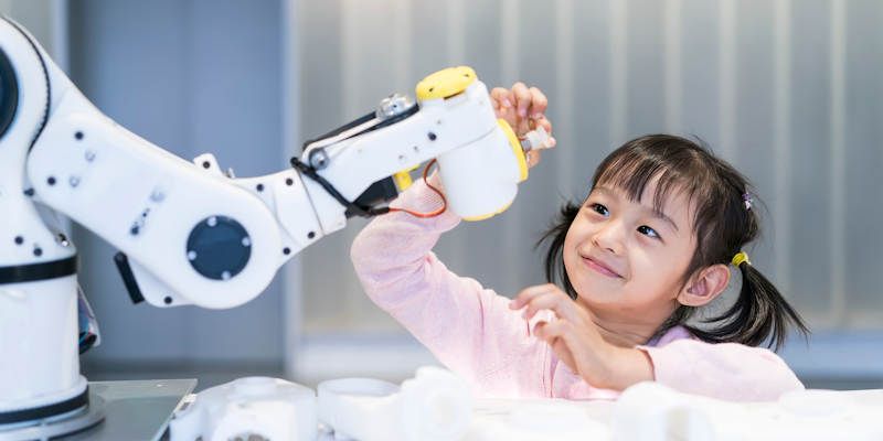 A child interacts with a robot