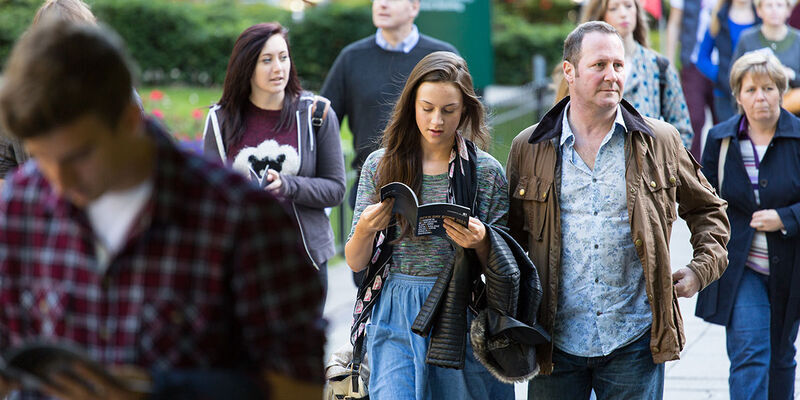 Students and their parents walking on campus at an open day