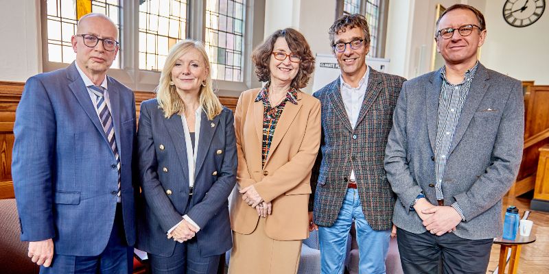 Professor Richard Beardsworth, West Yorkshire Mayor Tracy Brabin, Vice-Chancellor Professor Simone Buitendijk, Professor Piers Forster and Professor Andy Gouldson standing together on stage in the Great Hall at Leeds