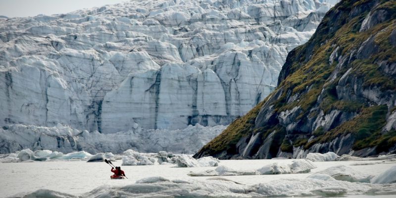 Two people in a canoe on ice marginal lake in southwest Greenland