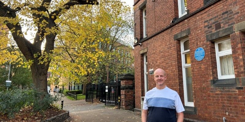 Nick Sheppard stood in front of the blue plaque highlighting the anti-slavery history of Leeds.
