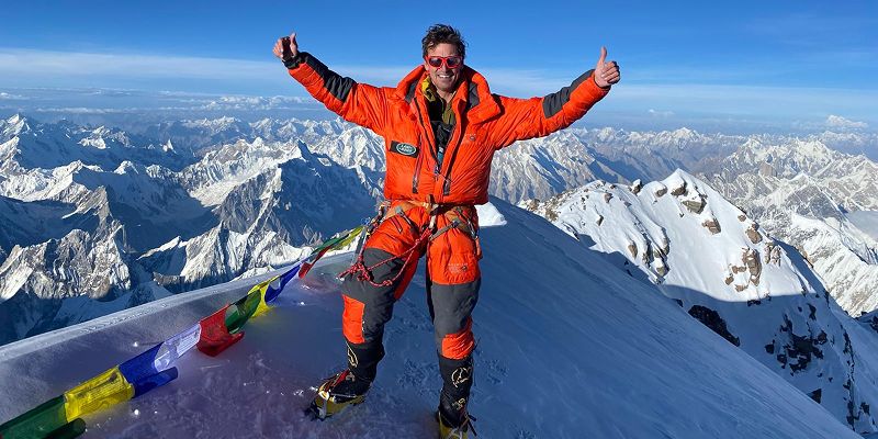 Kenton Cool celebrates with two thumbs up at the summit of K2