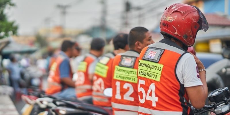 Motorcycle taxi drivers from the back.