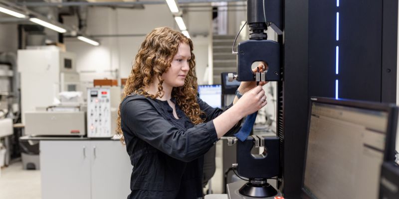 A researcher puts a garment through its paces at a testing station.