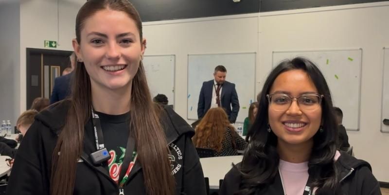 Third year law student Olivia Huyton and first year Criminology and Criminal Justice student Karola Das stand next to each other and talk to camera at the launch of the Junior Detectives programme.