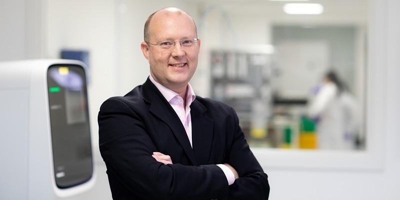 The image is a head and shoulders image of Dr Mark Wigglesworth, Site Director at the Alderley Park Lighthouse Lab in Cheshire.