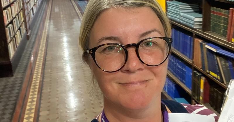 Lou is pictured stacking books in Leeds City Library