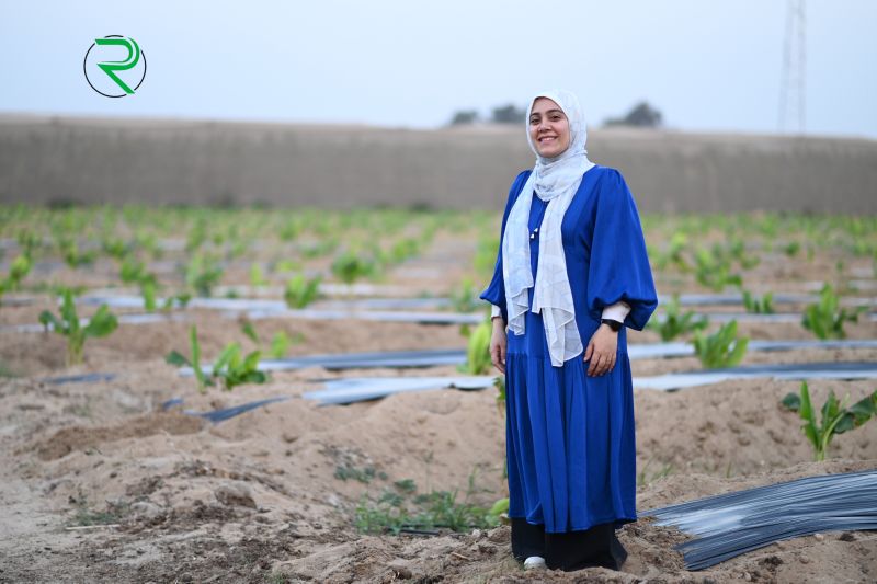 Aya Al Sharqawy stands in a field of crops in Egypt