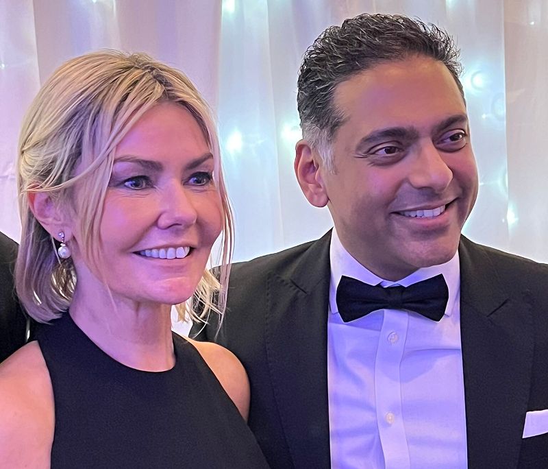 Two individuals stood together at a black tie event