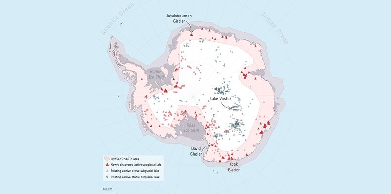 Illustrated map of Antarctica. Pink red shading along edge continent with white in the interior. Clusters of dark red triangles, light red triangles on continent edges and blue circles dotted throughout with large clusters centre left and bottom right. 