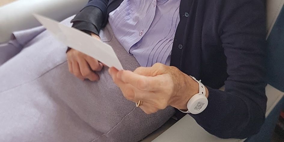 A care home resident wearing the contact tracing device on her wrist