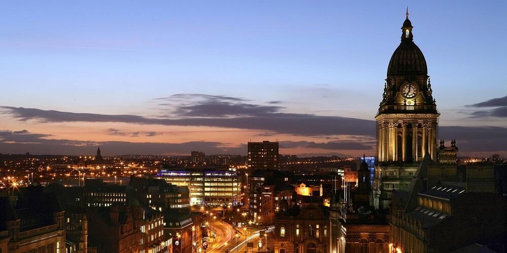 Skyline of Leeds featuring Leeds Town Hall and the streets below at sunset