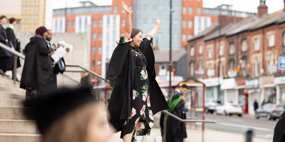 Student celebrates graduation on Parkinson steps