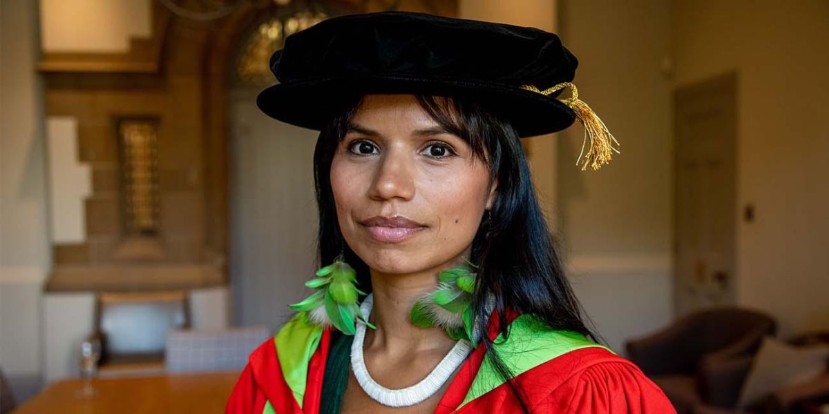 Headshot of Nina Gualinga in a graduation gown.