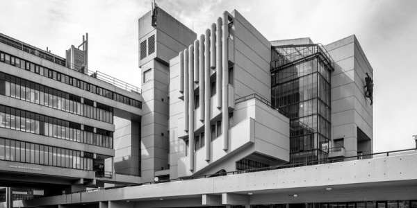 Black and white photo of the Roger Stevens Building: A large Brutalist -style structure at the University of Leeds