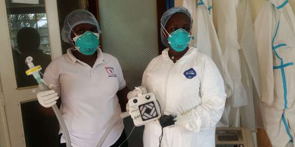 Staff at the Mengo hospital in Kampala, Uganda, show of the low-cost breathing device