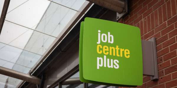 The Jobcentre Plus sign on the side of a brick building