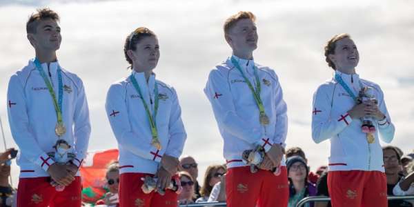 Team England triathlon mixed relay team stand on the podium to receive their medals