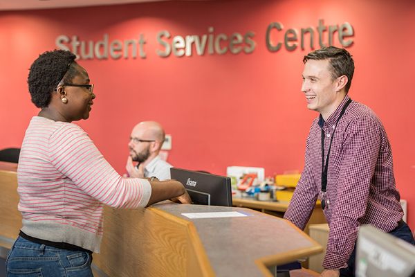 A student asks for advice at the student services centre.