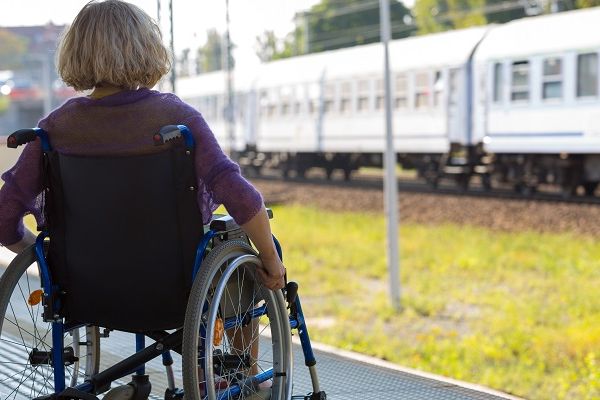 Woman in wheelchair on train platform