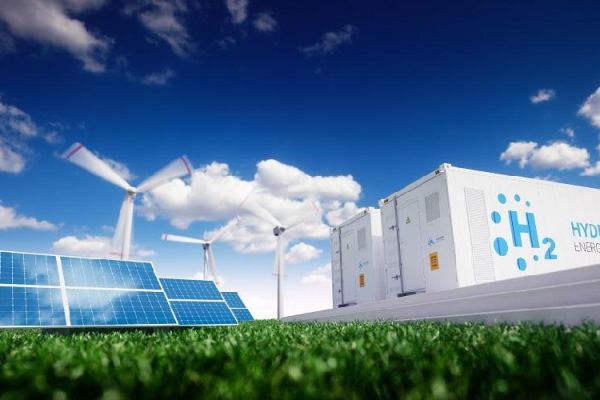 Solar panels, wind turbines and Hydrogen energy storage unit against blue sky