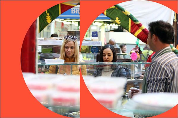 Two students browsing a market stall in Leeds.