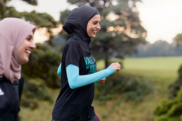 Namrah Shahid, founder of Hijabi Runners, running with a friend.