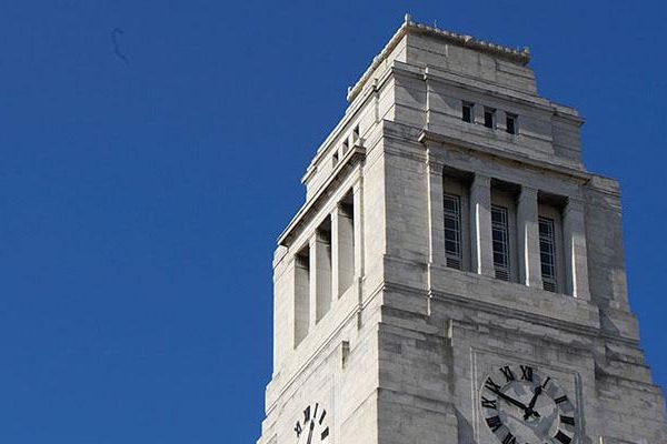 The top of the Parkinson Building tower against a clear blue sky