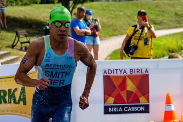 Tyler Smith runs out of the water during a triathlon race