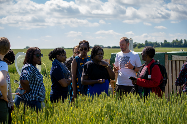 FSNet mentors and fellows stood in a field of crops at the University of Leeds farm, June 2022. Picture credit: Motus TV.