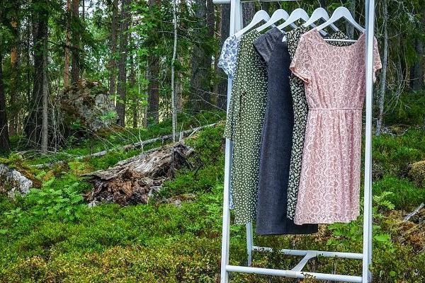 Dresses hanging on a clothing rail in a forest