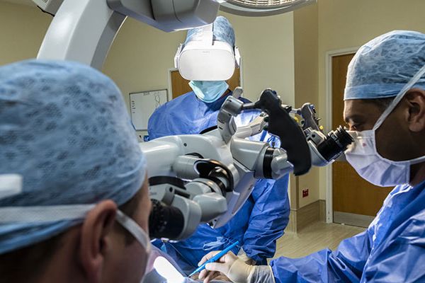 Surgeons wearing scrubs using immersive technology