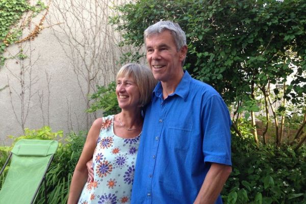 Sue and Peter Cullimore stand together in their garden