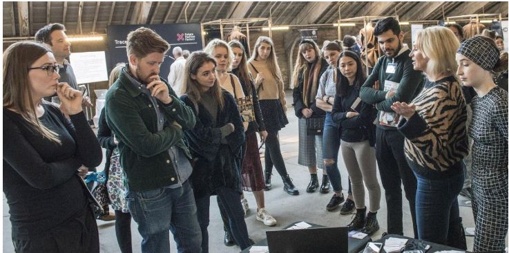 A group of textiles researchers and industry representatives networking at a Future Fashion Factory event