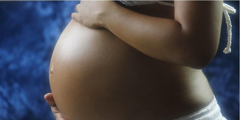 The picture shows the tummy of a pregnant woman.