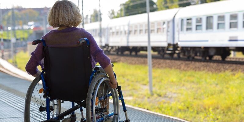 Woman in wheelchair on train platform