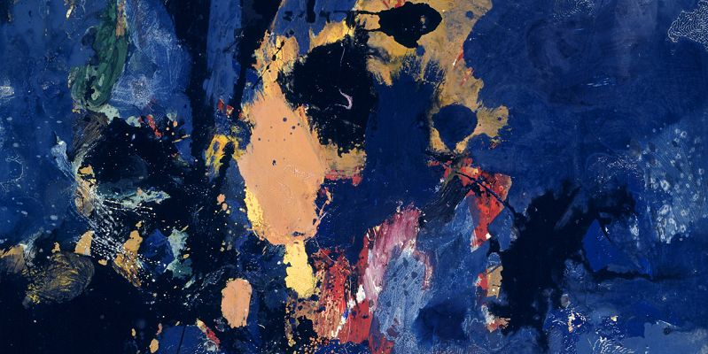 An abstract painting that is mainly dark blue with splodges of orange, black, red, white, yellow and green paint.