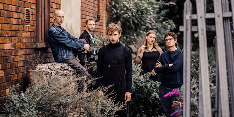 The five members of Jazz band, Doomtet, stand in a garden looking at the camera.