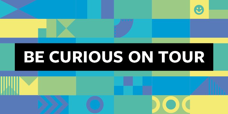 The text Be Curious On Tour on a green, blue and yellow background with circular shapes.