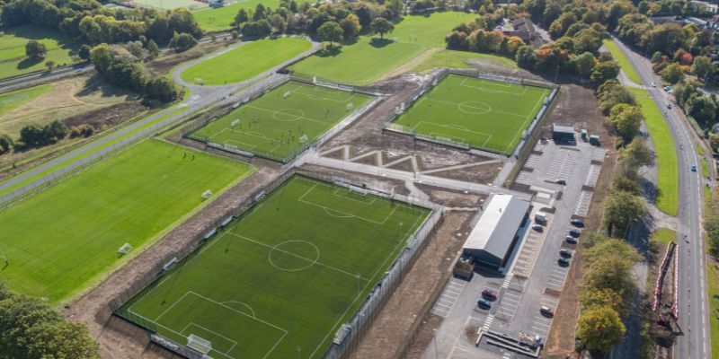an aerial photograph of three football pitches and buildings.