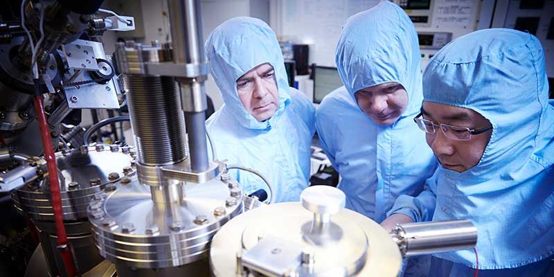 Bragg researchers wearing protective suits in the nanotechnology cleanroom