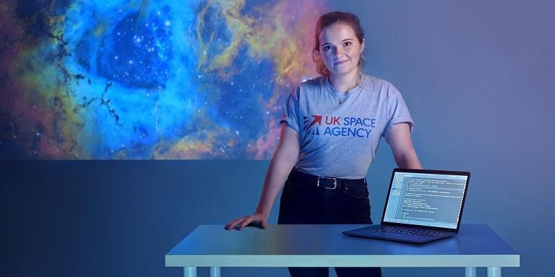 Student Ellie Sleightholm with a laptop with coding on the screen
