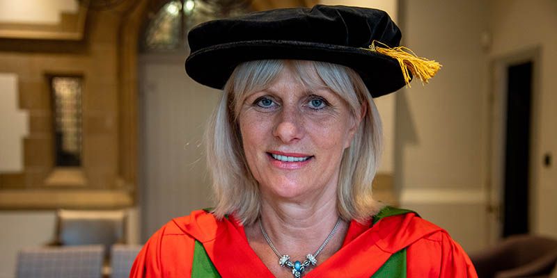 Portrait of Gillian Leng in graduation cap and gown.
