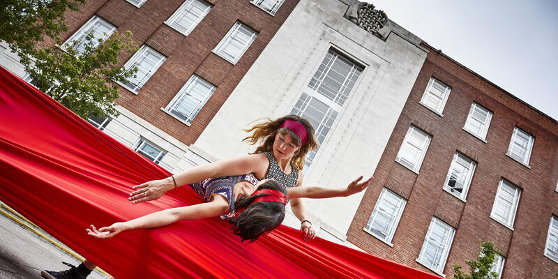 Dancers from Turvey World Dance in front of Man-Made Fibres, the Mitzi Cunliffe sculpture on what is now Clothworkers' South Building at the University of Leeds