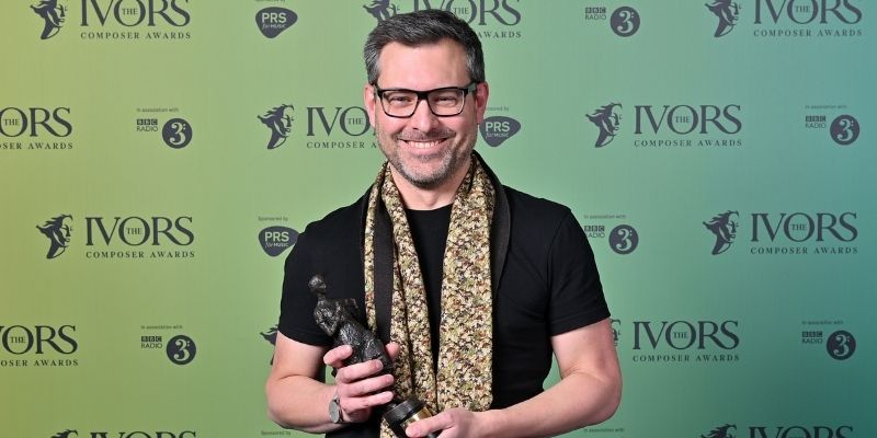 Professor Martin Iddon pictured smiling and holding an Ivor Novello Award