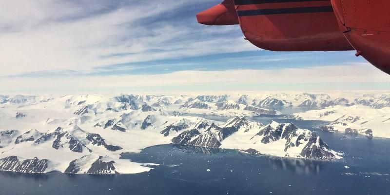 The Antarctic peninsula seen from an aircraft. Ice emerges from valleys and enters the sea.