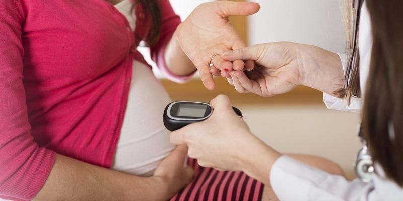 Picture shows a pregnant woman having her blood glucose level recorded
