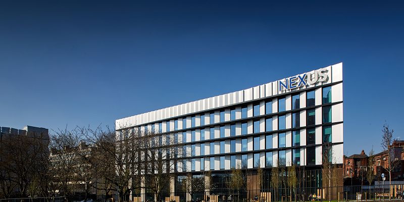 The image shows the front of the Nexus building on the campus of the University of Leeds